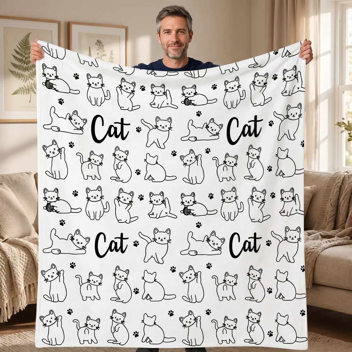 DIY coloring blanket, Cat & Yarn Ball design, held up in a living room