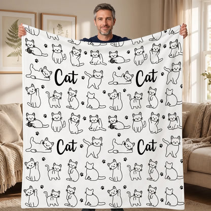 DIY coloring blanket, Cat & Yarn Ball design, held up in a living room