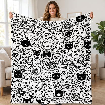 DIY coloring blanket, Multiple Cat Heads design, held up in a living room