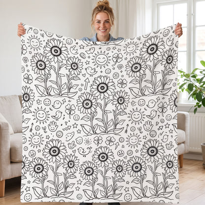 DIY coloring blanket, Sun & Sunflower design, held up in a living room