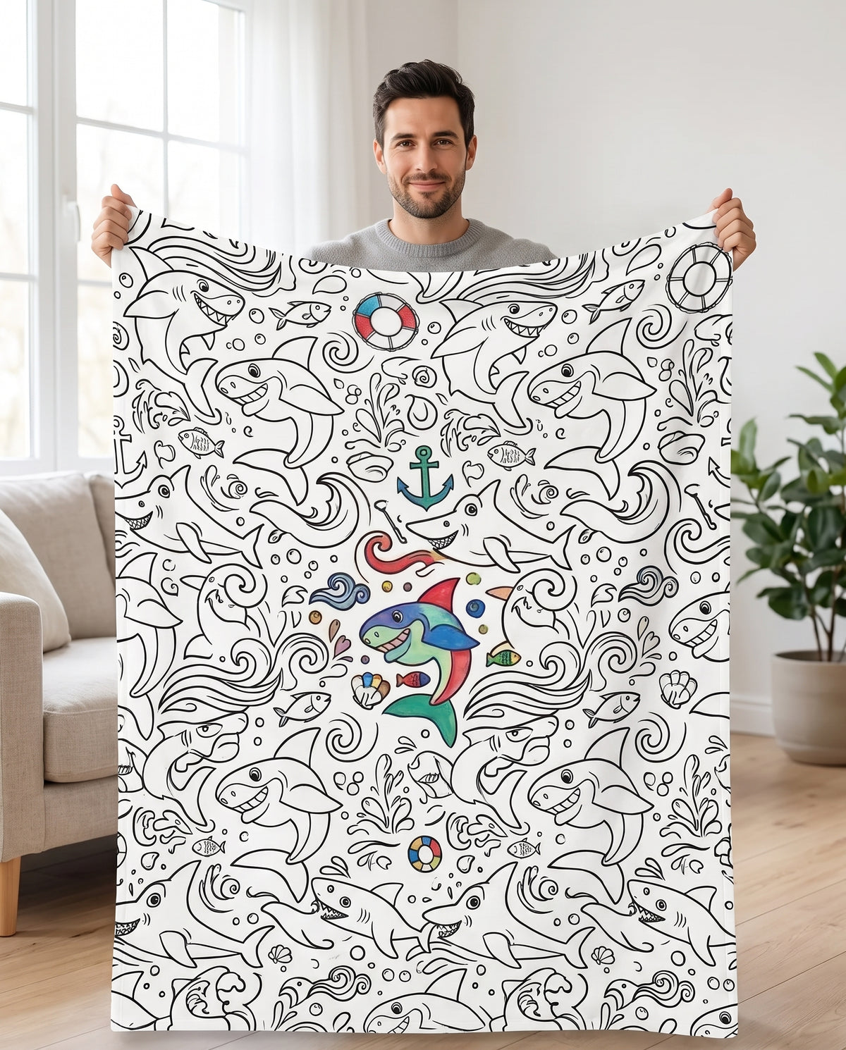 DIY coloring blanket, Sharks design, held up in a living room